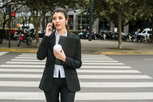 Young businesswoman crossing the street, taking a risk in doing so